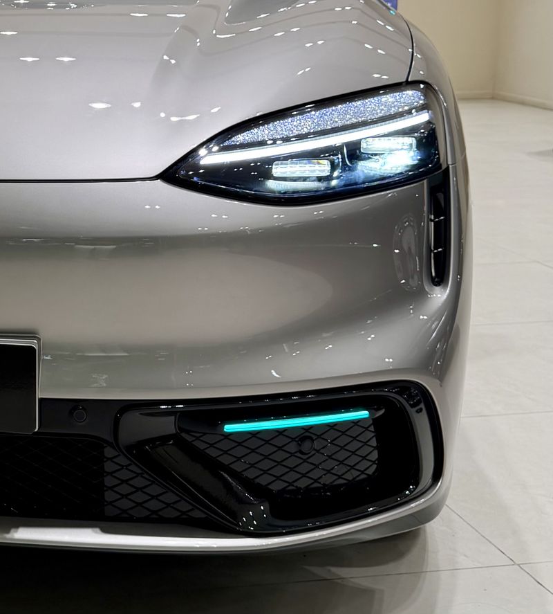 Turquoise headlights on the front grill of an Aito M6 SUV in Shanghai