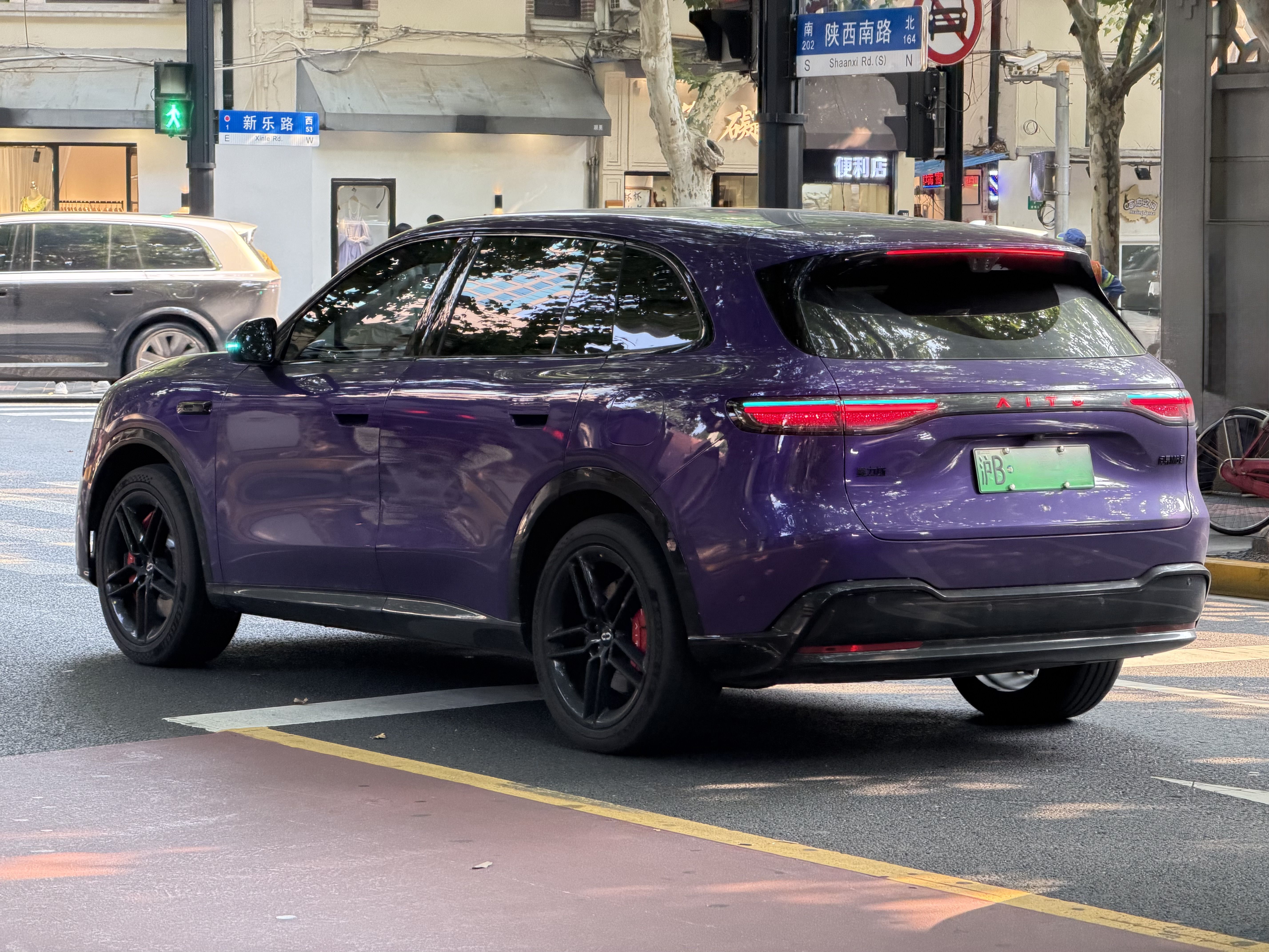 a car in traffic in shanghai featuring turquoise lights