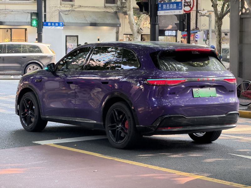 a car in traffic in shanghai featuring turquoise lights