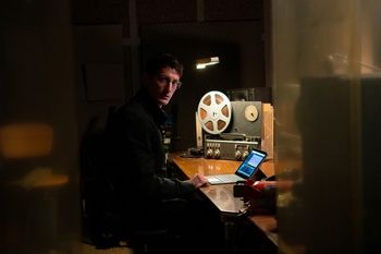 A person at a desk with a plane black box on it