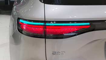 A closeup of a car taillights displaying a turquoise color over the regular red breaking light.