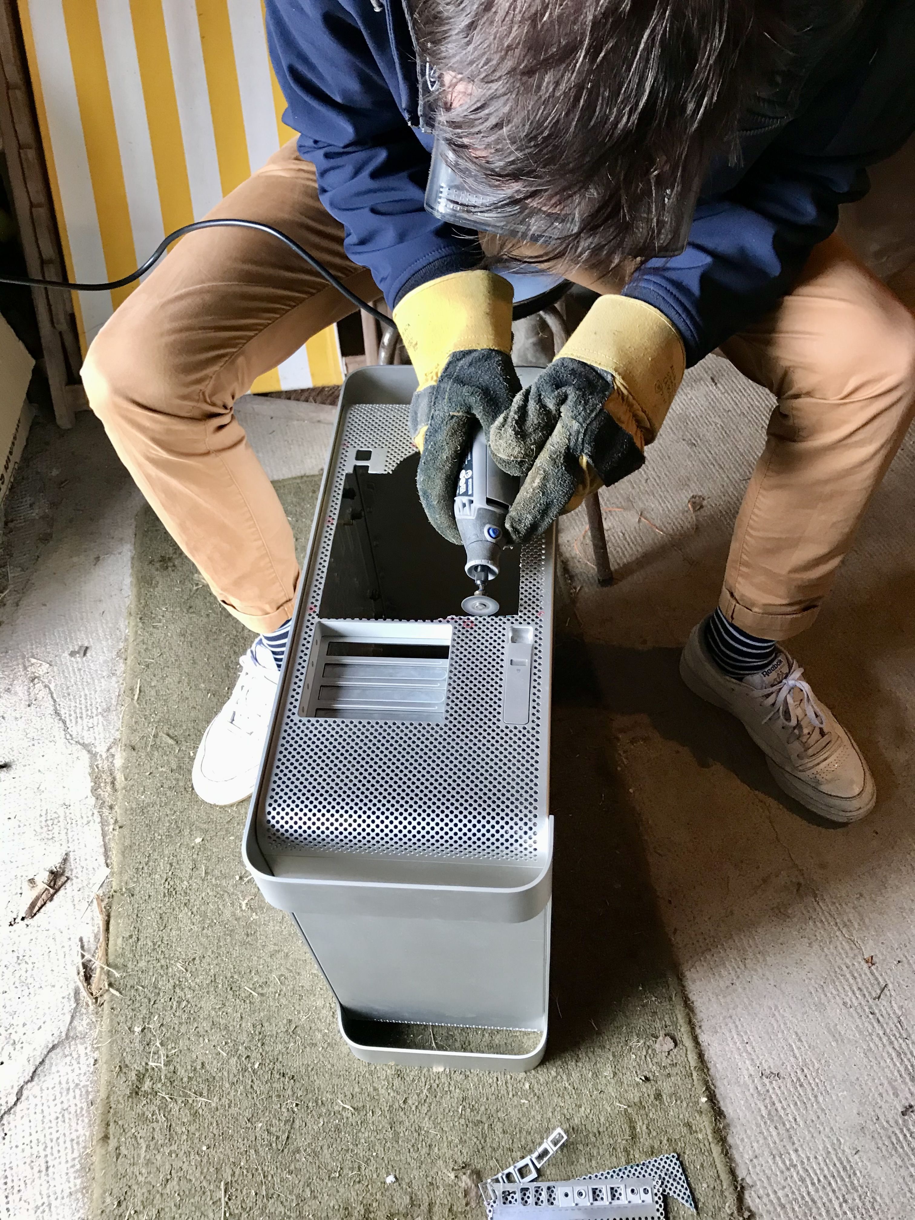 cutting the cas open with a Dremel in a garage